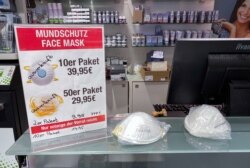A sign advertising protective face masks is marked "Sold out" inside a store in Berlin, Germany, Feb. 28, 2020.
