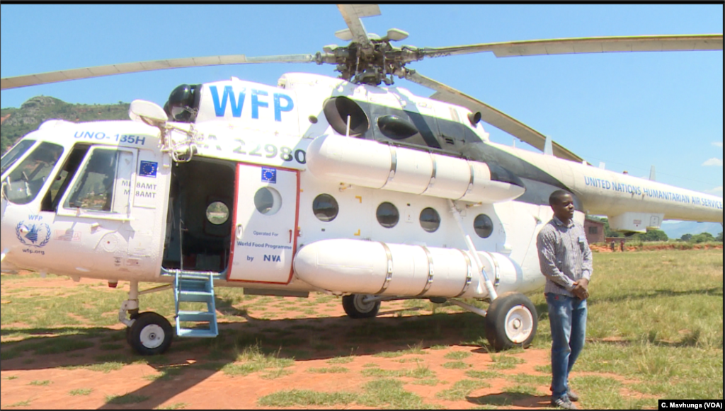 A World Food Program-owned helicopter lands in Ngunga, in Chimanimani district, March 26, 2019, with UNICEF equipment and chemicals to prevent waterborne diseases after the European Union funded the helicopter to fly. 