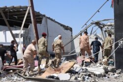 Officials examine a detention center after it was bombed in the war between Libya's competing governments in Tripoli, Libya, July 3, 2019. (Heather Murdock/VOA)