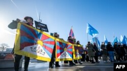 Tibetan and Uyghur activist stage a protest outside of the UN Offices at Geneva during the review of China's rights record by the United Nations Human Rights Council, Jan. 23, 2024.