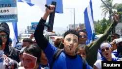 Demonstrators wearing traditional masks take part in a march called "Together we are a volcano" against Nicaragua's President Daniel Ortega's government, in Managua, Nicaragua, July 12, 2018.