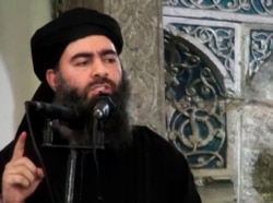 This file image made from video posted on a militant website July 5, 2014, purports to show Abu Bakr al-Baghdadi, delivering a sermon at a mosque in Iraq.