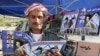 FILE - A man reads a copy of Israel-Kurd magazine in Irbil, Iraq, Aug. 16, 2009.