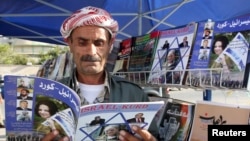 FILE - A man reads a copy of Israel-Kurd magazine in Irbil, Iraq, Aug. 16, 2009.