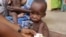 FILE - A doctor attends to a malnourished child at a refugee camp in Yola, Nigeria. Doctors Without Borders says nearly 200 refugees from Boko Haram have died of starvation and dehydration in the city of Bama in the past month. 