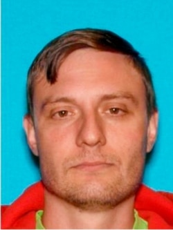 FILE - This undated Department of Motor Vehicles photo provided by the FBI shows Robert Alvin Justus Jr., who has been charged with aiding and abetting the murder and attempted murder of two Federal Protective Services security officers.