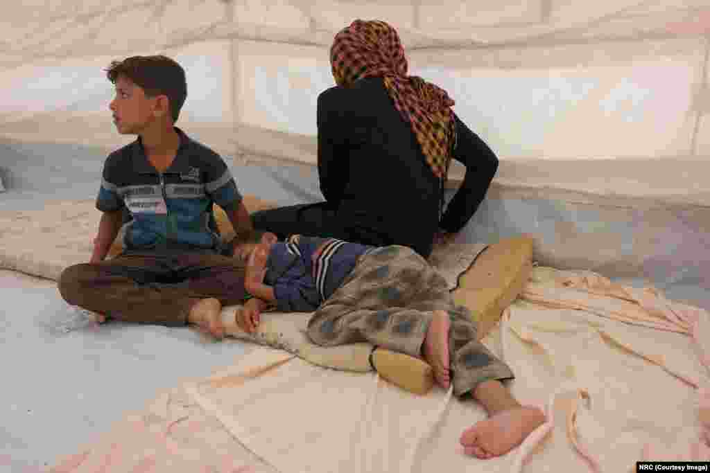 Mohammed (9, sitting up) told NRC, "My feet were very painful and tired after having to run all night." Ishwaq, her husband and their three children, all under the age of 12, managed to escape Fallujah on May 23, 2016. They ran during the night for three hours before arriving at the border checkpoint where they raised white flags made of cloths so they wouldn't be shot at.