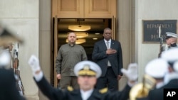 FILE - U.S. Defense Secretary Lloyd Austin, right, welcomes Ukraine's Defense Minister Rustem Umerov, left, to the Pentagon on Dec. 6, 2023, in Washington.