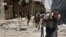 This Tuesday, July 9, 2013 citizen journalism image provided by Aleppo Media Center AMC, which has been authenticated based on its contents and other AP reporting, shows Syrian rebels running during heavy clashes with Syrian soldiers loyal to Syrian Presi