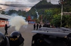 Riot police fire tear gas during a protest in Jayapura, Papua, Indonesia, Aug. 29, 2019 in this photo taken by Antara Foto.