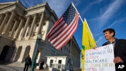 A man wearing a mask as a precaution against the Middle East Respiratory Syndrome (MERS) virus walks by a Spiderman poster in Seoul, South Korea.