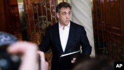 Michael Cohen, former attorney to President Donald Trump, holds a press conference outside his apartment building before departing to begin his prison term Monday, May 6, 2019, in New York. (AP Photo/Kevin Hagen)