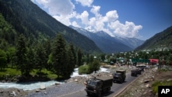 An Indian army convoy moves on the Srinagar- Ladakh highway at Gagangeer, north-east of Srinagar, India, June 17, 2020.