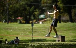 Liam Watkins balances on a slack line at Griffith Park in Los Angeles, April 16, 2020.
