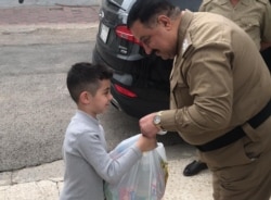 A man distributes food aid to poor families in Baghdad, April 7, 2020. (Photo courtesy of Haidar Aboud)