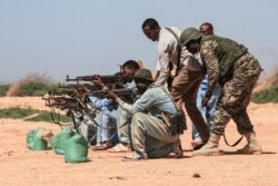 FILE - Ugandan instructors of African Union's peacekeeping mission in Somalia (AMISOM) coach Somali soldiers during their training session at the shooting range in Ceeljaale, Somalia, Sept. 19, 2019.