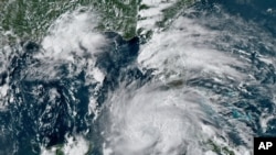 This GOES-16 East GeoColor satellite image taken Aug. 27, 2021, at 4:40 p.m. EDT, and provided by NOAA, shows Hurricane Ida crossing western Cuba.