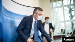 Lothar Wieler (L), head of Germany's disease control agency Robert Koch Institute (RKI), is seen during a news conference on the current situation regarding the coronavirus pandemic, in Berlin, Germany, Dec. 22, 2020. 