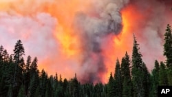 Smoke from the Creek Fire billows beyond a ridge as seen from Huntington Lake, California, Sept. 5, 2020.