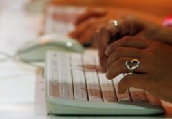 FILE - Internet users browse at an underground station in Hong Kong.