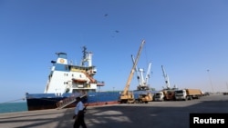 FILE - A coast guard walks past a ship docked at the Red Sea port of Hodeida, Yemen, Jan. 5, 2019. 