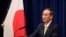 FILE - Japanese Prime Minister Yoshihide Suga speaks at a news conference in Tokyo, Dec. 4, 2020. 
