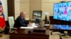 Presiden Rusia Vladimir Putin berbicara dalam rapat kabinet virtual dari kediamannya di Novo-Ogaryovo di luar Kota Moskow, Rusia, pada 16 Maret 2022. (Foto: Russian Presidential Press Service via AP)
