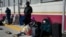 Asylum-seekers with appointments made through the U.S. Customs and Border Protection CBP One application wait at the entrance of the Camino Real International Bridge in Piedras Negras, Coahuila, Mexico, Jan. 20, 2025.