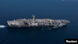 FILE - The Nimitz-class aircraft carrier USS Abraham Lincoln transits the Strait of Gibraltar, entering the Mediterranean Sea, April 13, 2019.