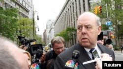 FILE - Lawyer John Dowd is met with reporters as he exits Manhattan Federal Court in New York, NY, U.S., May 11, 2011. 