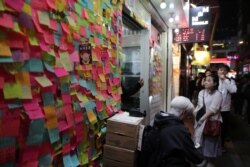 Protesters queue for a free Christmas dinner offered by a local restaurant in Hong Kong, Dec. 25, 2019.