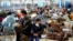 FILE - Evacuees from Afghanistan wait with other evacuees to fly to the United States or another safe location in a makeshift departure gate inside a hangar at the U.S. airbase in Ramstein, Germany, Sept. 1, 2021. 
