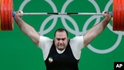 Alpacas, male Romeo (L) and female Juliette, decorated for Valentine's Day walk inside their open air enclosure at the Roev Ruchey Zoo in Krasnoyarsk, Russia.