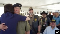 Vietnam veteran Ignacio Perez becomes emotional as Luci Baines Johnson, daughter of president Lyndon B. Johnson, pins a medal on his shirt at the Vietnam War Summit at the LBJ Presidential Library in Austin, Texas on Wednesday, April 27, 2016.