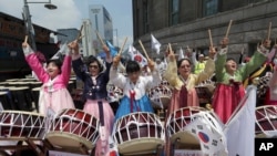Christian believers beat drums during a protest opposing the homosexuality and same-sex marriage near the venue where thousands of supporters participating to celebrate the 16th Korea Queer Festival in Seoul, South Korea, June 28, 2015.