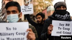 Activists affiliated with Civil Society hold placards during a protest against Myanmar's military after seizing power from a democratically elected civilian government and arresting its leader Aung San Suu Kyi, in Kathmandu, Nepal, Feb. 1, 2021.