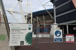 FILE - Coronavirus signs are seen in the city center as the coronavirus disease (COVID-19) outbreak continues in Cardiff, Wales, Britain, Oct. 19, 2020.