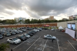 Movie audiences sit in their parked cars as they watch "Living in Bondage" at a drive-in cinema, following the relaxation of lockdown, amid the coronavirus disease (COVID-19) outbreak in Abuja, Nigeria, May 20, 2020.