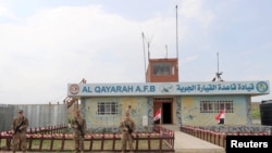 FILE - U.S. soldiers stand guard during the hand over of Qayyarah Airfield West to Iraqi Security Forces, in the south of Mosul, Iraq, March 26, 2020.