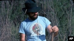 In this June 1982 self portrait, C. Kenneth Dodd Jr. holds a pink Grand Canyon Rattlesnake. Dodd was participating in a survey of riparian areas along the Colorado River with the National Park Service and the U.S. Fish & Wildlife Service. (Courtesy of C. Kenneth Dodd Jr. via AP)