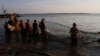 FILE - Ethnic Vietnamese fishermen collect catches from the Mekong river near Arey Ksat village at the outskirt of Phnom Penh, Cambodia, Feb. 6, 2014.
