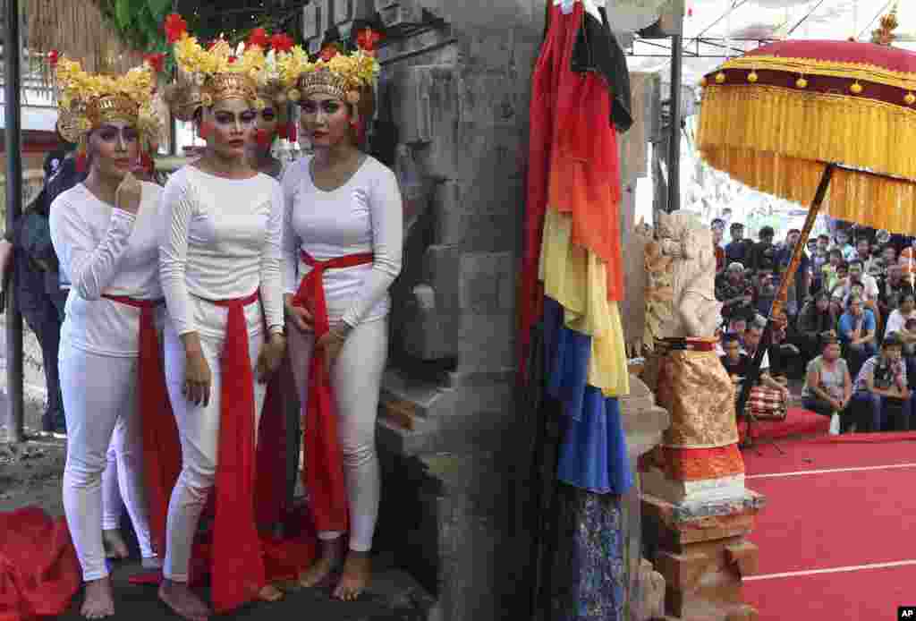 Dancers wait at backstage as they prepare for a dance performance during the Bali Arts Festival in Bali, Indonesia.