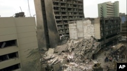 FILE - The U.S. Embassy, left, is pictured with blasted ruins next to it in downtown Nairobi, Kenya, Aug. 8, 1998, the day after terrorist bombings in Kenya and Dar es Salaam, Tanzania.