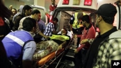 A wounded Shi'ite Bahraini demonstrator is taken to a hospital in Manama after being assaulted by riot police on February 17, 2011