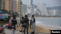 Members of the federal forces keep watch at a beach as Hurricane Otis barrels towards Acapulco, Mexico, Oct. 24, 2023.