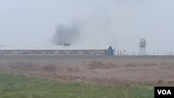 FILE - Smoke appears to rise from Qarchak prison near Tehran, Iran, in a photo first published online by Iranian Dervish news outlet Majzooban Noor on Feb. 8, 2019. The European Union put an asset freeze on the prison, one of the Iranian regime's detention facilities for women.