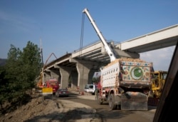 FILE - Work is in progress at a new international trade route near Havalian in Pakistan, May 11, 2017, as part of China's Belt and Road Initiative.
