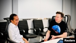 Indonesian President Joko Widodo reacts while talking with Founder and CEO of Tesla Motors Elon Musk during their meeting at the SpaceX launch site in Boca Chica, Texas