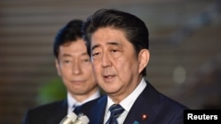 FILE - Japan's Prime Minister Shinzo Abe speaks to reporters at Abe's official residence in Tokyo, June 6, 2018.