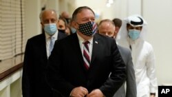 U.S. Secretary of State Mike Pompeo walks into a meeting with the Taliban's peace negotiation team amid talks between the Taliban and the Afghan government, in Doha, Qatar, Nov. 21, 2020.